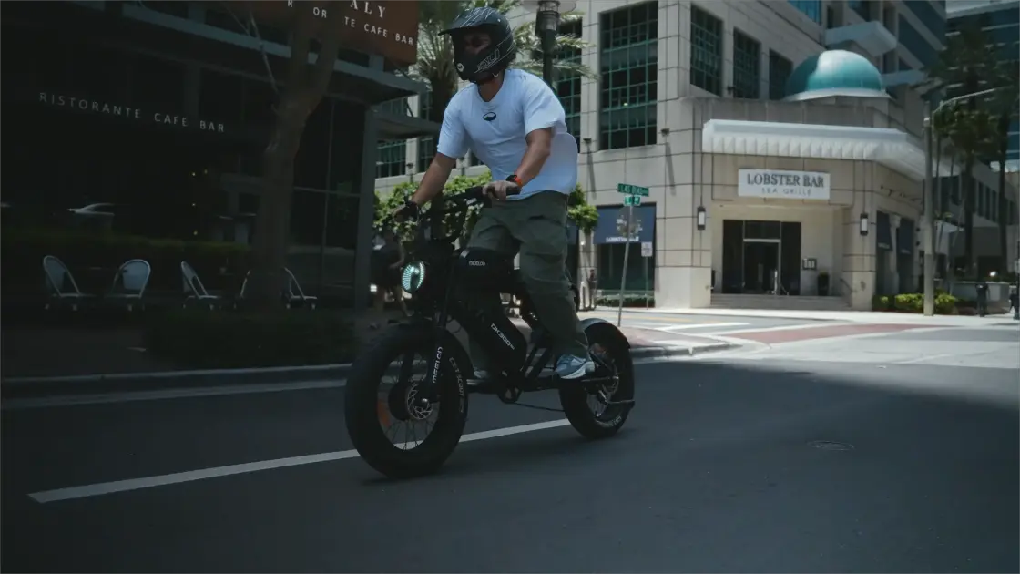 Rider performs stunts on the road on a fat-tire electric bicycle