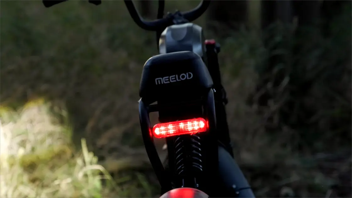 adult wearing helmet on electric bike in traffic